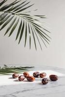 Dates on a marble table with palm leaves photo