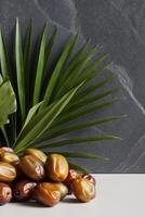 Dates and palm leaves on a white table photo