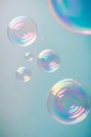 Soap bubbles floating in the air on a blue background photo