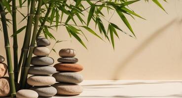 A stack of stones and bamboo in front of a white wall photo