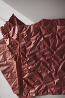 A piece of red paper folded into a triangle photo