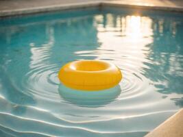 An inflatable yellow ring floating in a pool photo