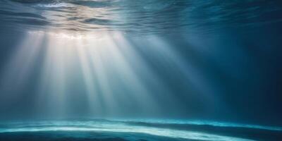 Underwater light beams shining through the water photo