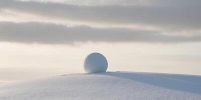 A white egg sitting on top of a snowy hill photo