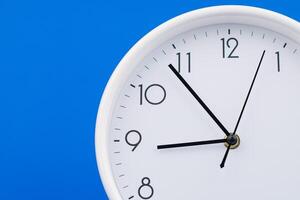 Clock telling time and working on time photo in studio on blue background