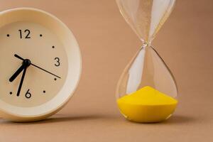 Hourglass tells the time limit and time constraint. Time-bound work. The process of time running out quickly. photo