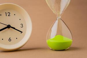 Hourglass tells the time limit and time constraint. Time-bound work. The process of time running out quickly. photo