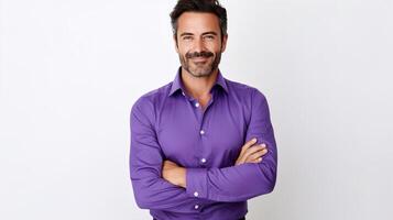 A man in a purple shirt standing with his arms crossed photo