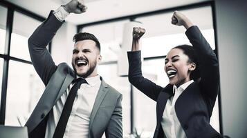 Two business people celebrating in an office photo