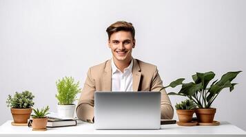 A man in a suit sitting at a desk with a laptop photo