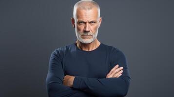 An older man with a beard and a blue shirt photo