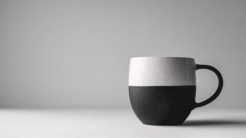 A black and white coffee mug on a table photo