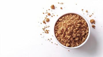 A bowl of brown sugar on a white surface photo