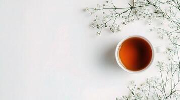 Cup of tea with flowers on white background photo