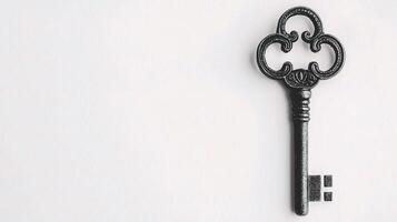 An old key on a white background photo