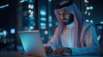 Arab man working on laptop at night photo