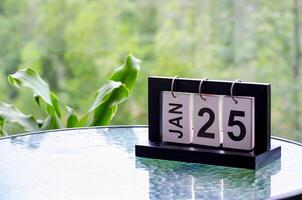 25 January calendar table with blurred nature background. With customizable space for text or ideas photo