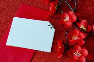Top view of blank notepad with Chinese New Year decoration. Copy space and Chinese New Year celebration. photo