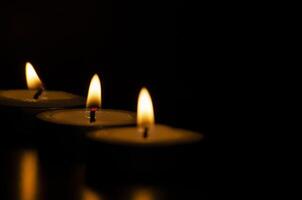 Candles shining in the dark with customizable space for message, text or ideas. photo