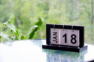 18 January calendar table with blurred nature background. With customizable space for text or ideas photo
