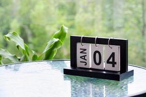 4 January calendar table with blurred nature background. With customizable space for text or ideas photo