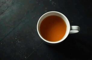 Glass mug warm tea on dark background, drink for restaurant menu photo