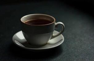 Glass warm mug tea on dark background, drink for restaurant menu photo