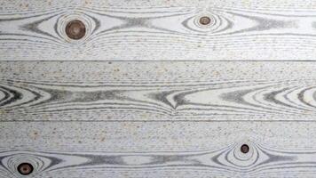 Close-up of textured wood panel with knot patterns and grey grain lines photo