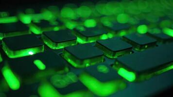 Close-up of green backlit keyboard with glowing keys photo
