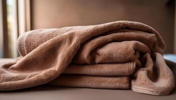 Soft brown fleece blanket on a bed indoors in natural light photo