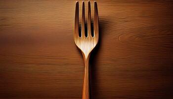 Wooden fork on textured wooden surface photo