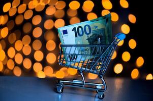 Trolley with 100 euro notes on the background of blurred bokeh lights photo
