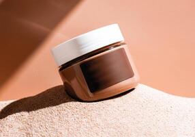 Cosmetic jar on sand. minimalist aesthetic with earthy tones photo