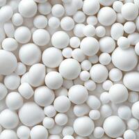 A large group of white balls of different sizes and shapes photo