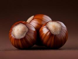 A close up of three hazelnuts on a brown surface photo