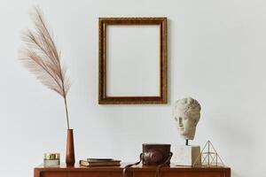 Stylish composition of artist workspace room with design retro teak commode, mock up poster frame, book, decoration and painting accessories. Template. photo
