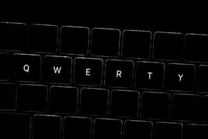 QWERTY. Night computer keyboard close up, keyboard light, dark theme bad password for your account photo