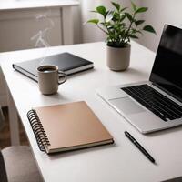Minimalist workspace with laptop, notebook, and coffee cup photo