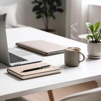 Minimalist workspace with laptop, notebook, and coffee cup photo