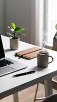 Minimalist workspace with laptop, notebook, and coffee cup photo