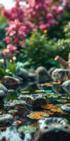 Tranquil garden pond with colorful flowers and smooth stones in serene nature setting photo