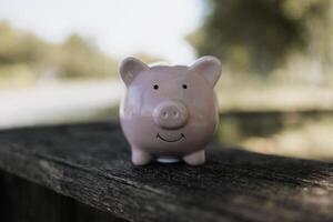 A pin piggy bank on the table. saving money, investment, currency concept photo