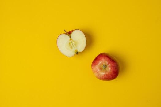 Flat lay composition with many red apples on yellow background. Space for text photo