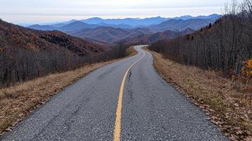 Winding road through mountains with stunning autumn scenery photo