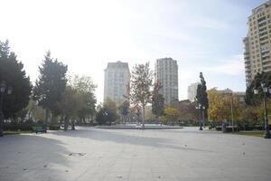 City Square with Autumn Trees and Buildings photo