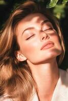 Woman with flawless skin basks in dappled sunlight, her eyes closed and hair softly framing her face, embodying natural beauty and tranquillity photo
