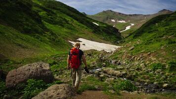 Traveling In Mountains Valley In Summer Or Spring Day, Back View Of All Hiker With Camera In Hand video