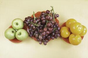 Grapes,Oranges and Apples put on background photo