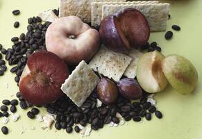 Plum and peach fruit put beside,plenty of coffee beans around, photo