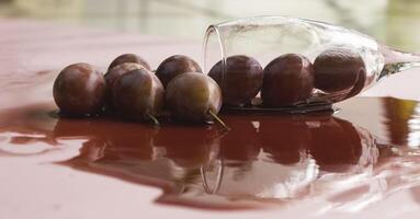 Group of Plum fruit put on wet background from red wine, photo